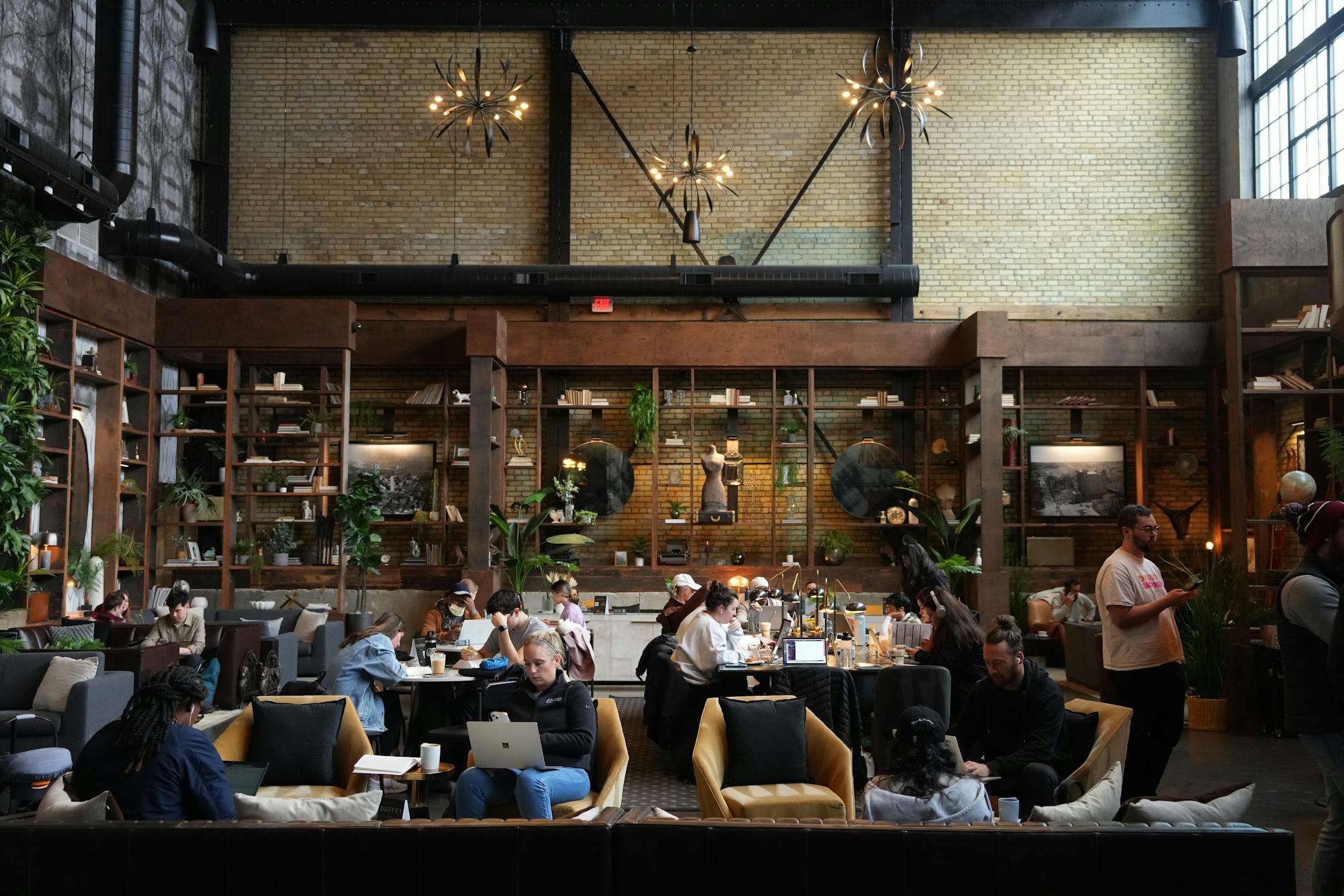 Patrons sat about in the expansive space at Backstory Coffee, which doubles as the lobby of the Duffey Lofts.