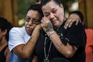 Friend Alicia Smith,left, comforts Melissa Waukazo, the sister of William "Billy" Hughes after a ceremony for her brother on Monday, Aug. 6, 2018 in S