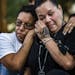 Friend Alicia Smith,left, comforts Melissa Waukazo, the sister of William "Billy" Hughes after a ceremony for her brother on Monday, Aug. 6, 2018 in S