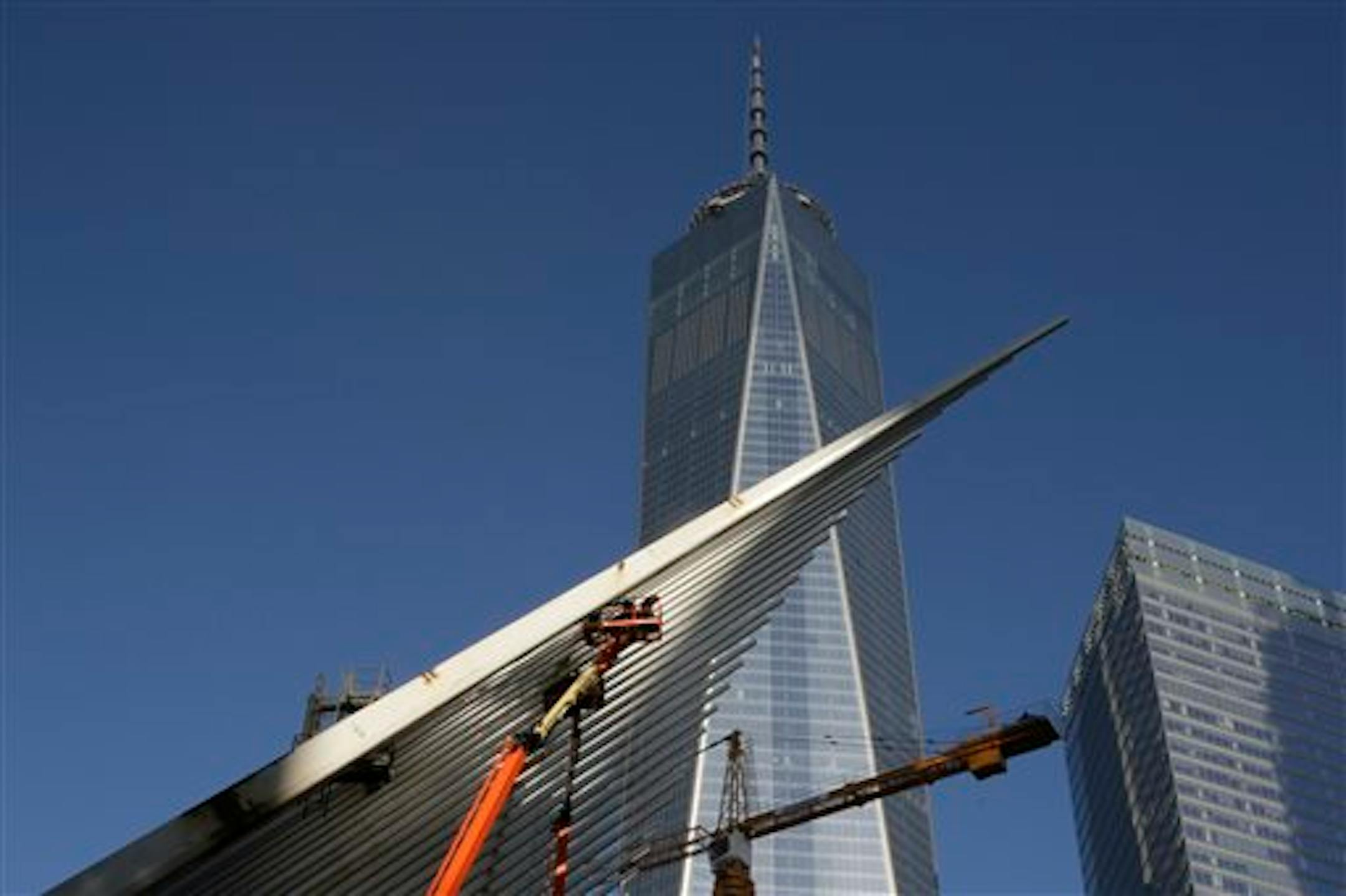 Work continues on the World Trade Center Transportation Hub, foreground, adjacent to the One World Trade Center building, background center, in New York, Monday, March 23, 2015. The first stair-climb benefit will be held at One World Trade Center in May to raise money for military veterans, two foundations, the Stephen Siller Tunnel to Towers Foundation and the Captain Billy Burke Foundation, formed after the 9/11 attacks announced Monday. (AP Photo/Richard Drew)