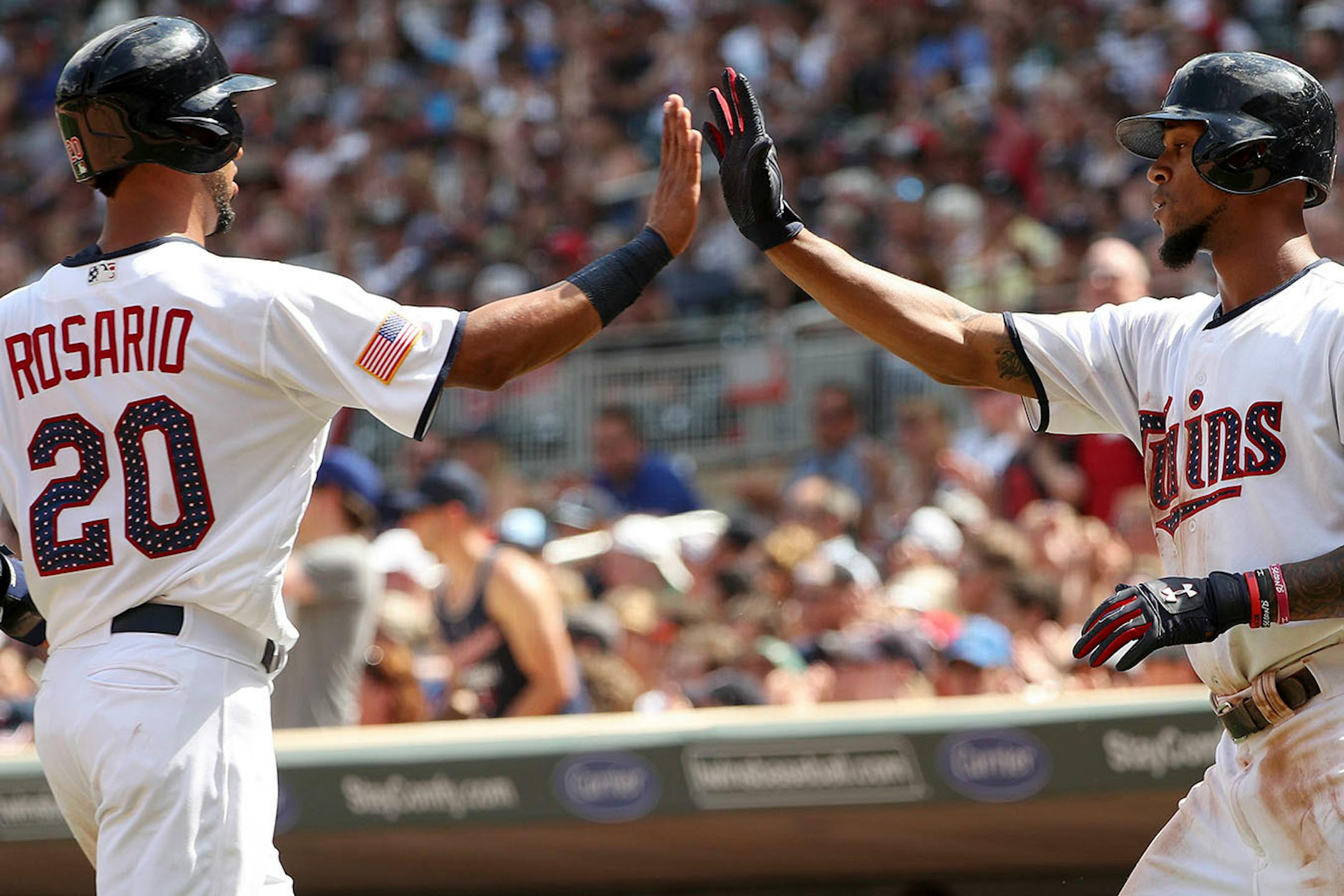 Minnesota Twins left fielder Eddie Rosario (20) celebrated with Minnesota Twins center fielder Byron Buxton (25) after scoring in the sixth inning.