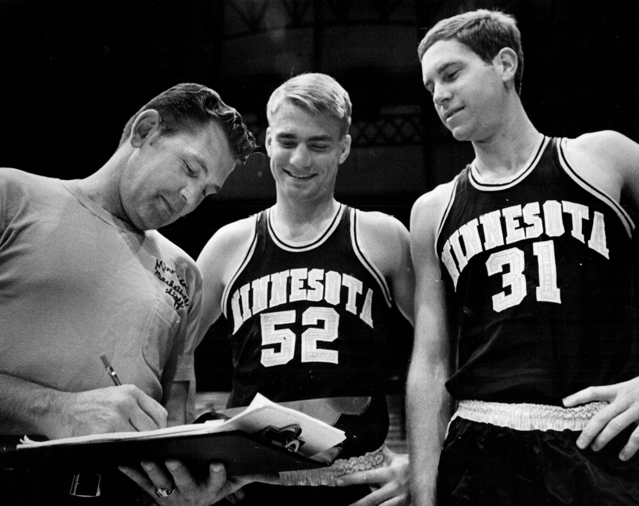 October 15, 1969 You Go Here, and . . . ketball coach Bill Fitch (left) gave instructions Tuesday to Gopher captains Larry Overskei (center) and Larry Mikan as the team got ready to start practice today for the 1969-1970 season. October 14, 1969 John Croft, Minneapolis Star Tribune