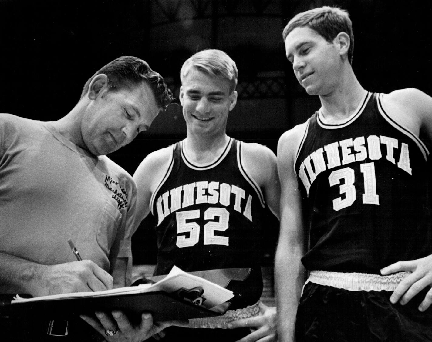 October 15, 1969 You Go Here, and . . . ketball coach Bill Fitch (left) gave instructions Tuesday to Gopher captains Larry Overskei (center) and Larry Mikan as the team got ready to start practice today for the 1969-1970 season. October 14, 1969 John Croft, Minneapolis Star Tribune