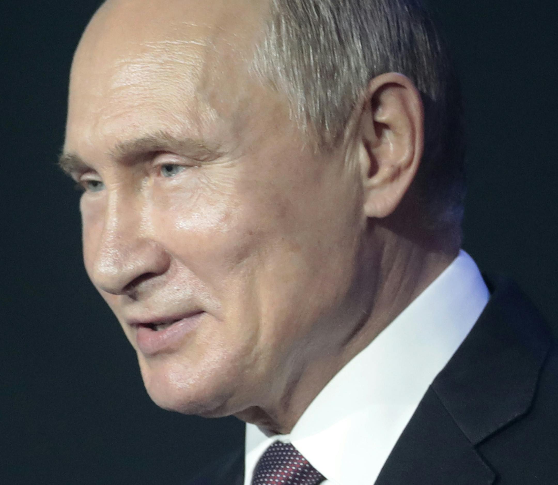 Russian President Vladimir Putin gestures while speaking at a cybersecurity conference in Moscow, Russia, Friday, July 6, 2018. Putin said it's important to develop common cybersecurity standards that take into account interests of all nations. (Sergei Chirikov/Pool Photo via AP)