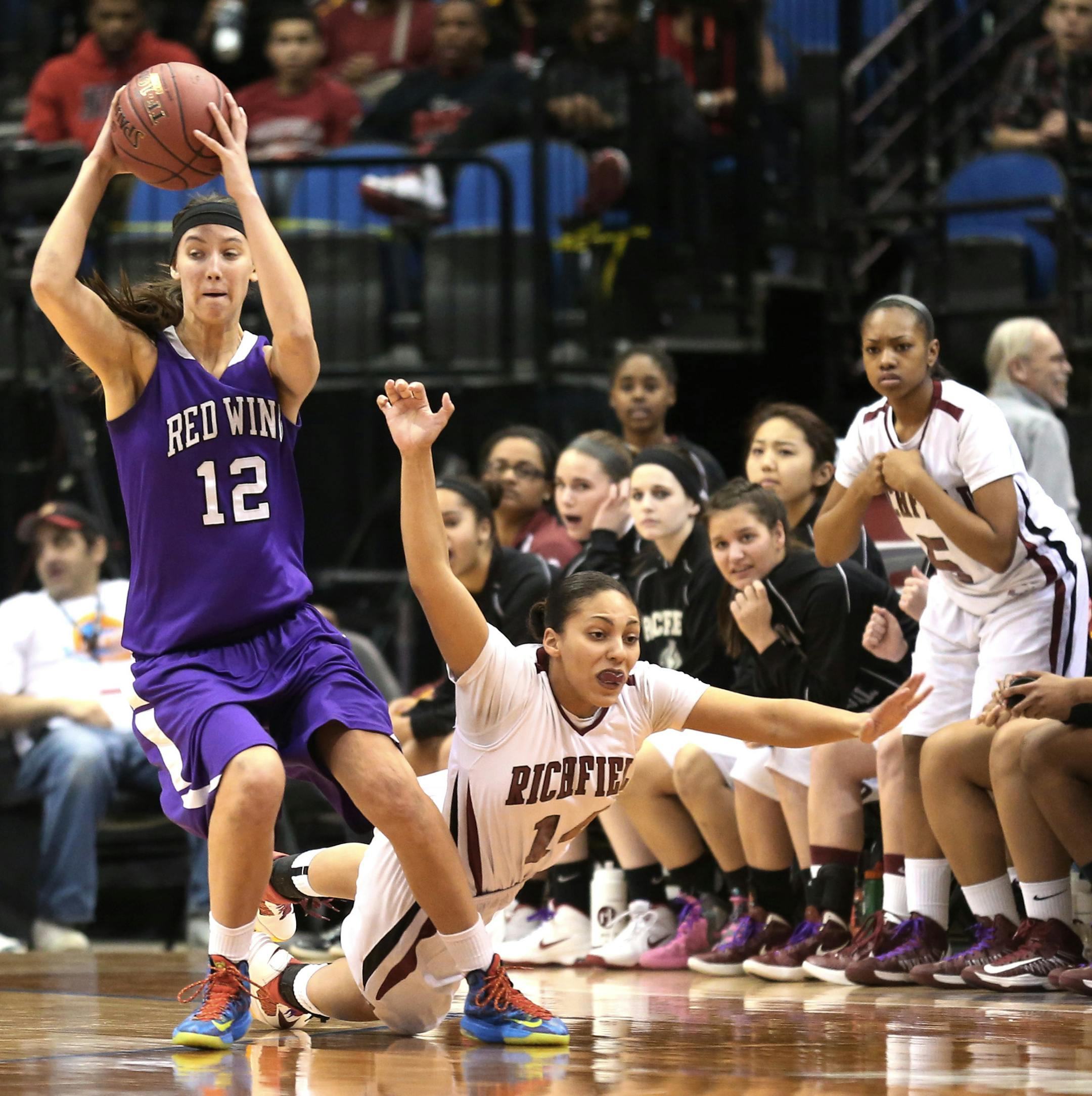 Jessica January of Richfield fell to the floor trying to steal the ball from Tesha Buck during Class 3A girls semifinals basketball action between Richfield and Red Wing Thursday March, 14, 2012 at Target Center, in Minneapolis, MN. Red Wing beat Richfield 61-59. ] JERRY HOLT ‚Ä¢ jerry.holt@startribune.com