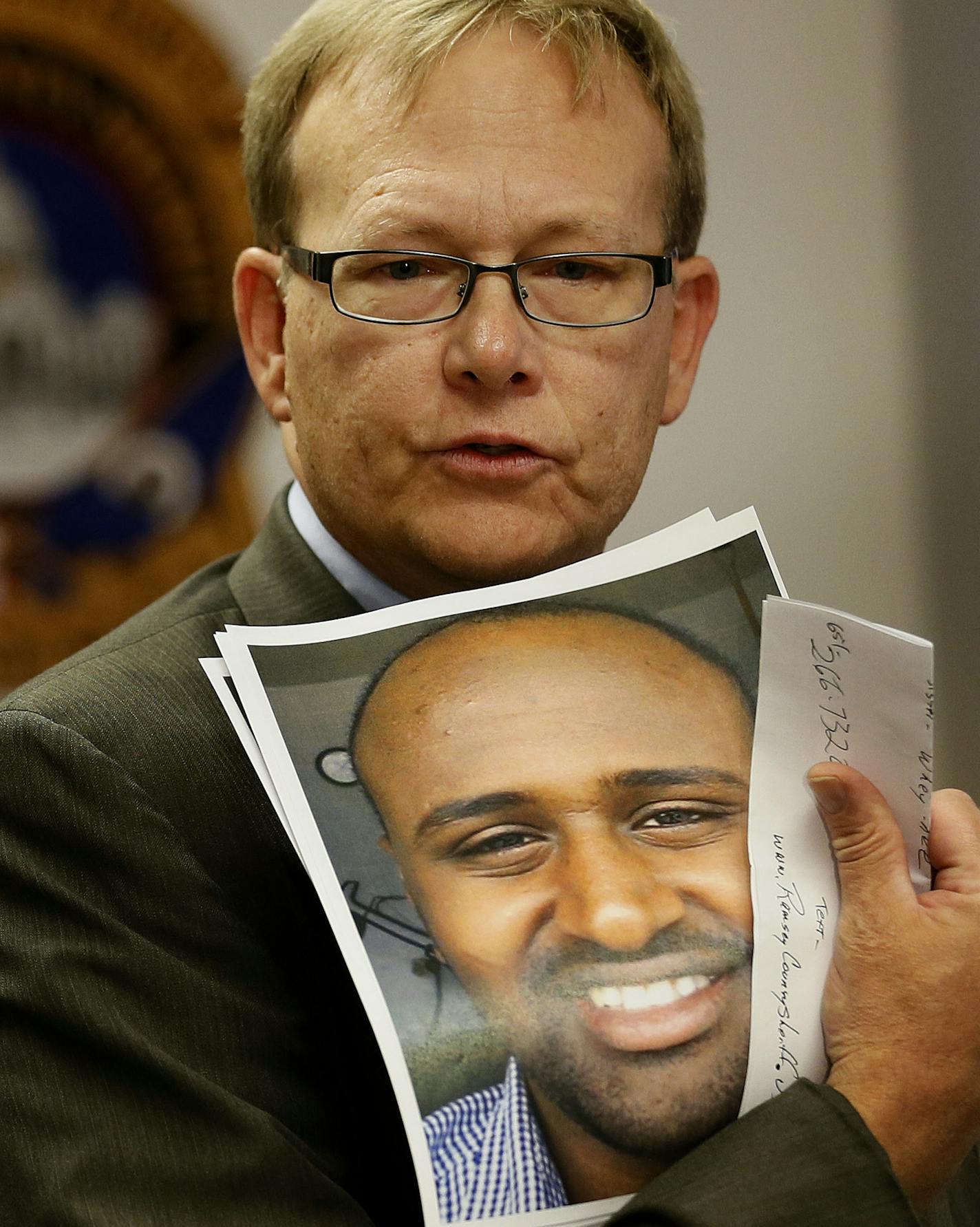 Randy Gustafson public information officer for the Ramsey County Sheriff's office held a photograph of Hagos Tsegay Melake who was murdered last month. Family members of Hagos Tsegay Melake and community members gathered at the Ramsey county Sheriff's office to appeal to the public for help in finding out who killed him Wednesday September 25, 2013 Arden Hills , MN.] JERRY HOLT &#x201a;&#xc4;&#xa2; jerry.holt@startribune.com