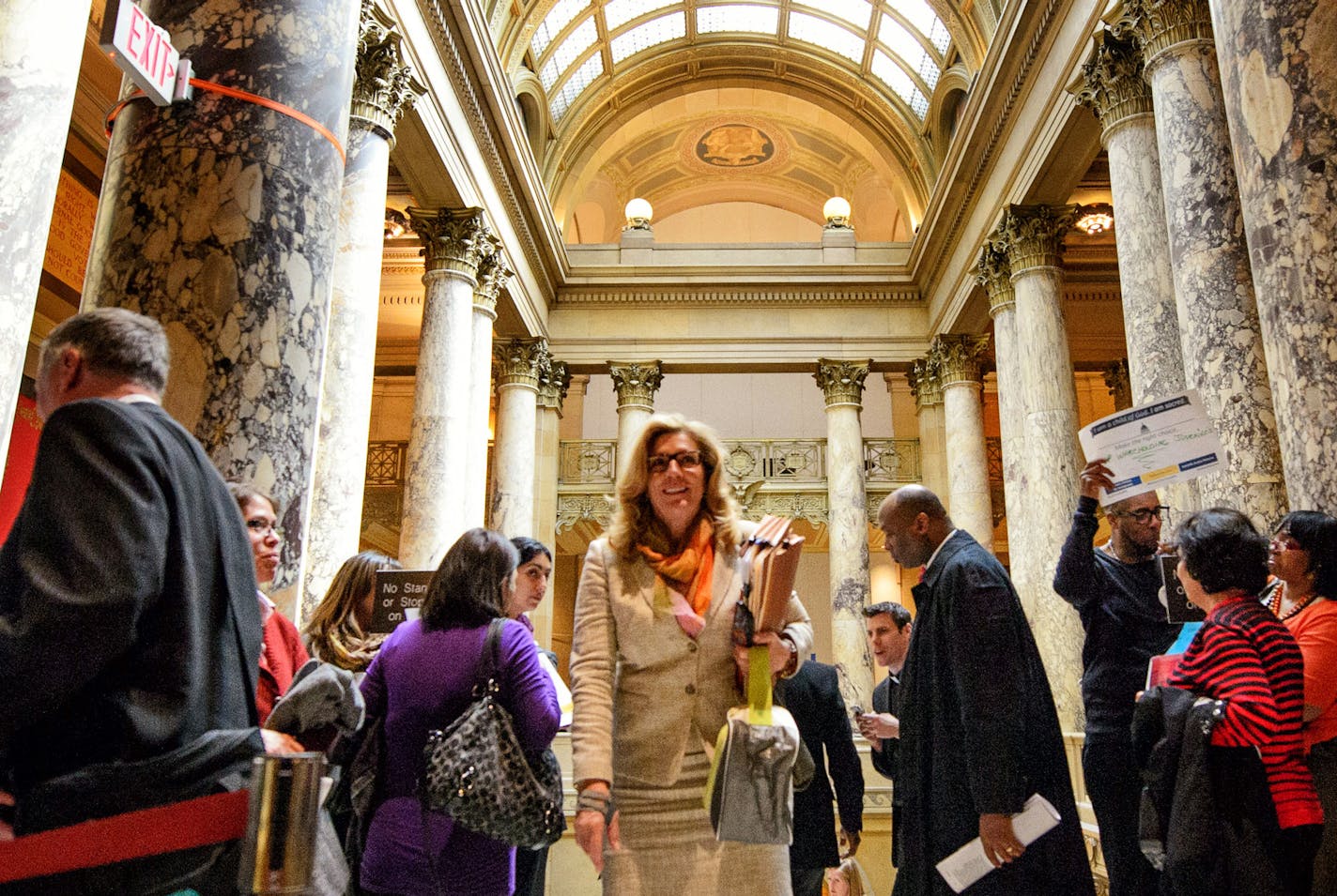 Senator Julie Rosen, R-Vernon Center, made her way past ISAIAH members gathered outside the Senate Chamber. ] GLEN STUBBE * gstubbe@startribune.com Thursday, April 23, 2015 Drivers license legislation has been added to the Senate Transportation Omnibus Bill. Prior to the vote, members of ISAIAH visited with legislators and held a faith rally and prayer vigil outside of the Senate chamber in the State Capitol.