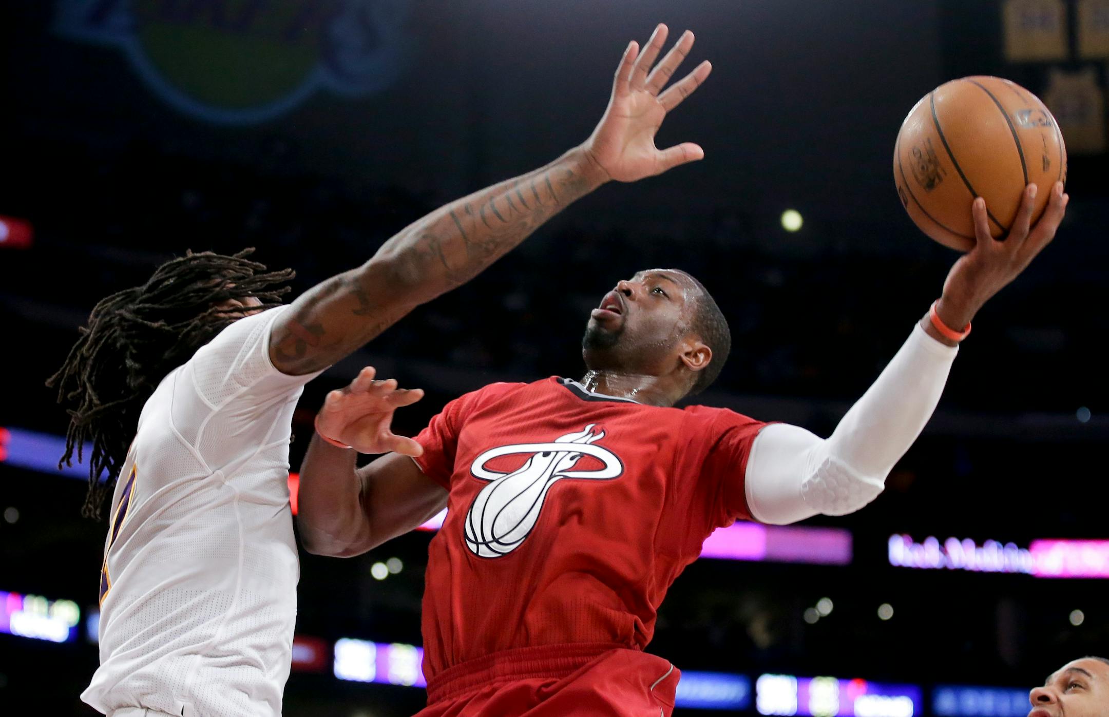 Miami Heat guard Dwyane Wade shot over Los Angeles Lakers center Jordan Hill during the second half of their game on Christmas Day 2013.