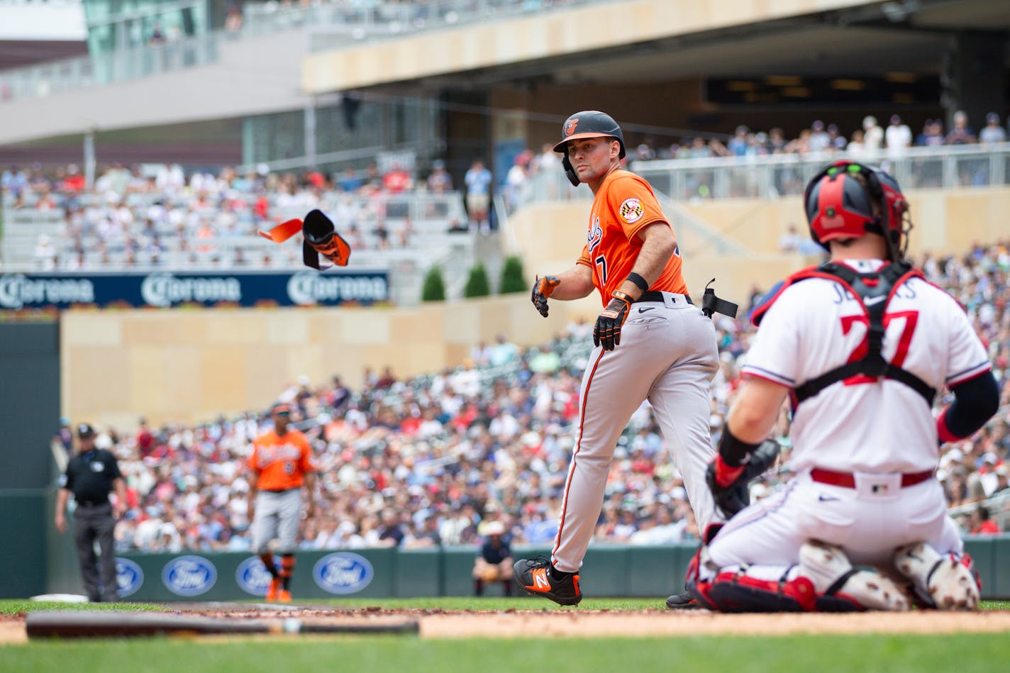 Baltimore's Colton Cowser tosses his batting gear away after drawing a walk against Twins starting pitcher Sonny Gray in the second inning Saturday