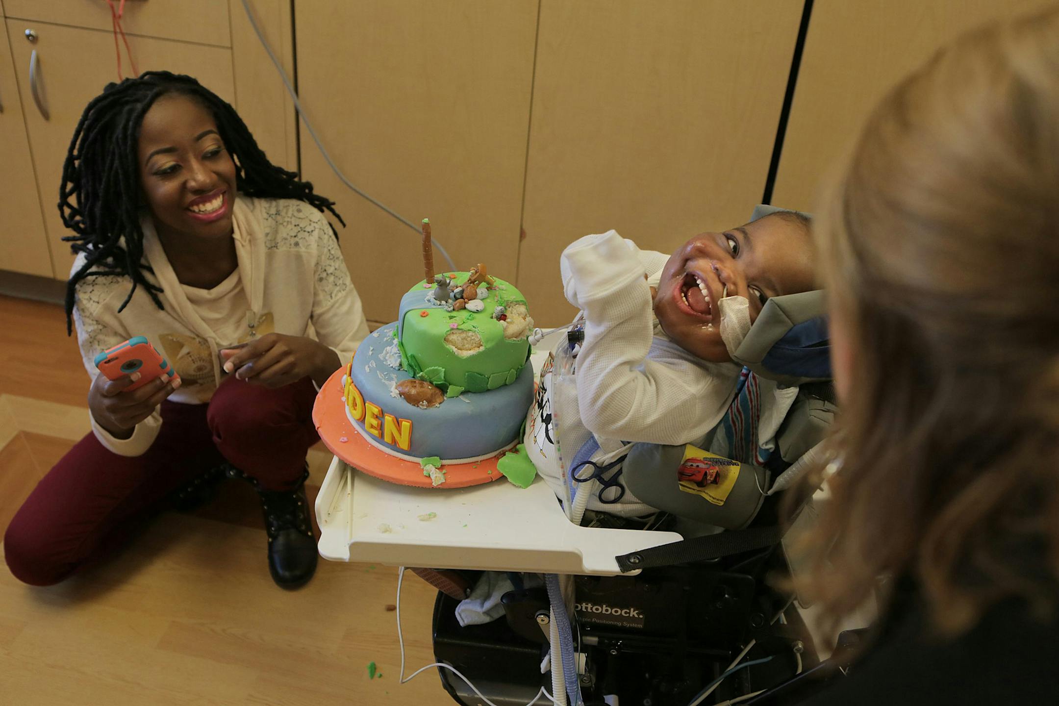 Kindness Singano, left, watches her son, Ke'aiden Proctor, play with his cake, something he refused to do last year, at his second birthday party on Saturday, Nov. 14, 2015 at Children's Hospital in St. Louis. Ke'aiden was born at 27 weeks and has chronic lung disease. He requires around-the-clock care at the neonatal intensive-care unit. (Hy Mach/St. Louis Post-Dispatch/TNS)