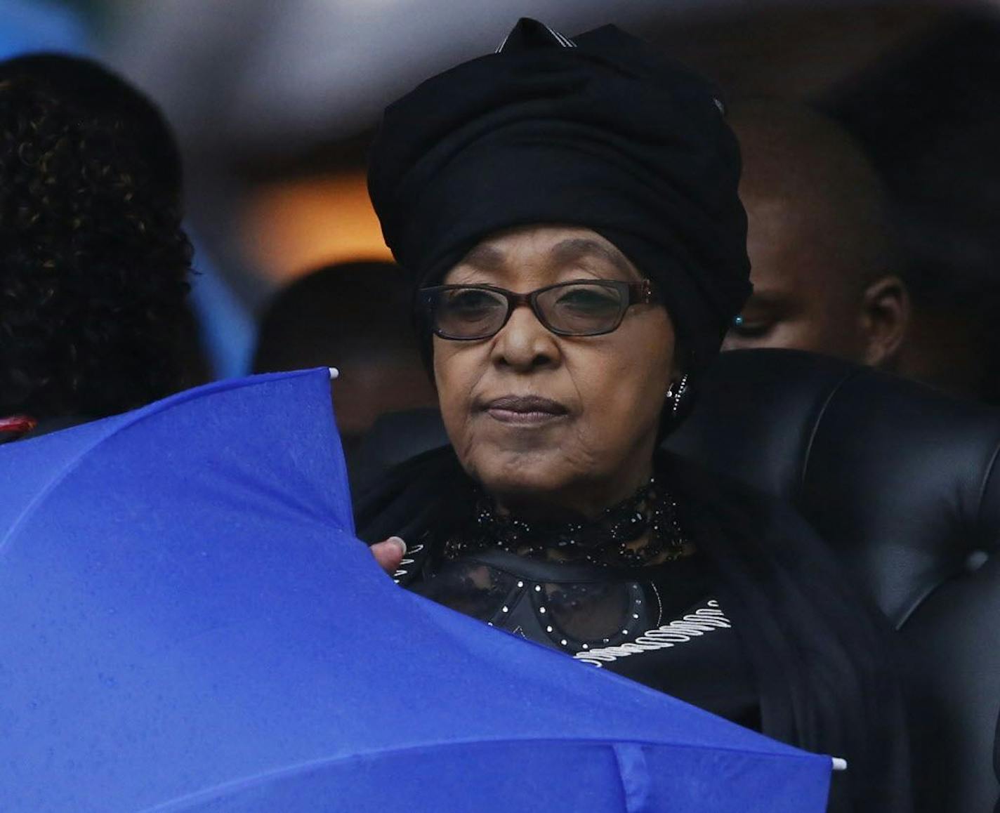 FILE -- In this Dec. 10, 2013 file photo Winnie Madikizela-Mandela listens to speeches during the memorial service for her ex-husband, former South African president Nelson Mandela at the FNB Stadium in Soweto, Johannesburg.