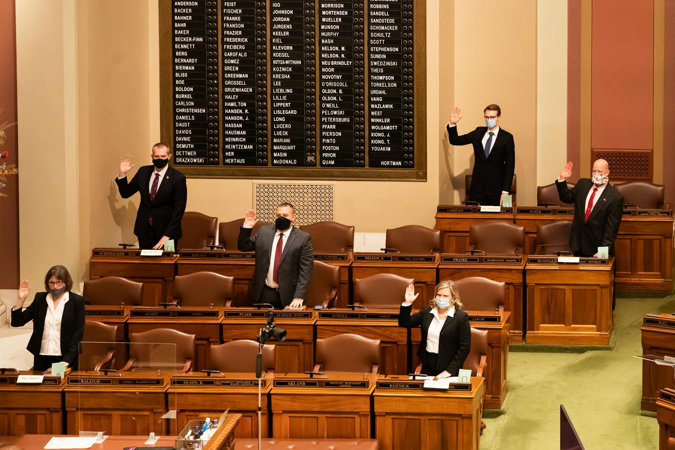 A few legislators are sworn in in person at the House Chamber on Tuesday. The Minnesota House passed a rule saying members and employees must wear face coverings.