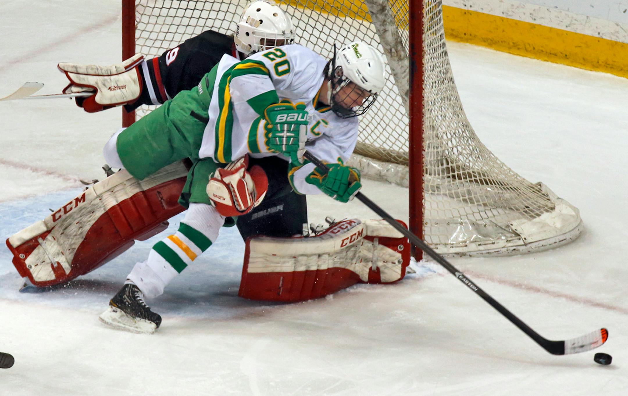 Edina's Dylan Malmquist skated around Lakeville North goalie Jake Oettinger as he attempted a shot in last year's Class 2A boys' hockey championship game.