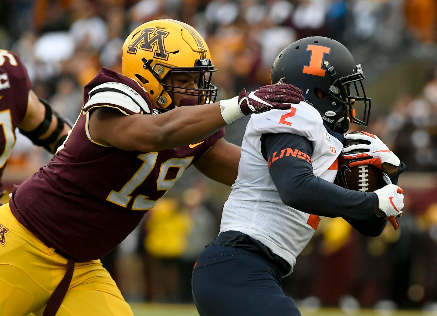 Gophers defensive lineman Keonte Schad (19) tackled Illinois running back Reggie Corbin (2) in the first half.