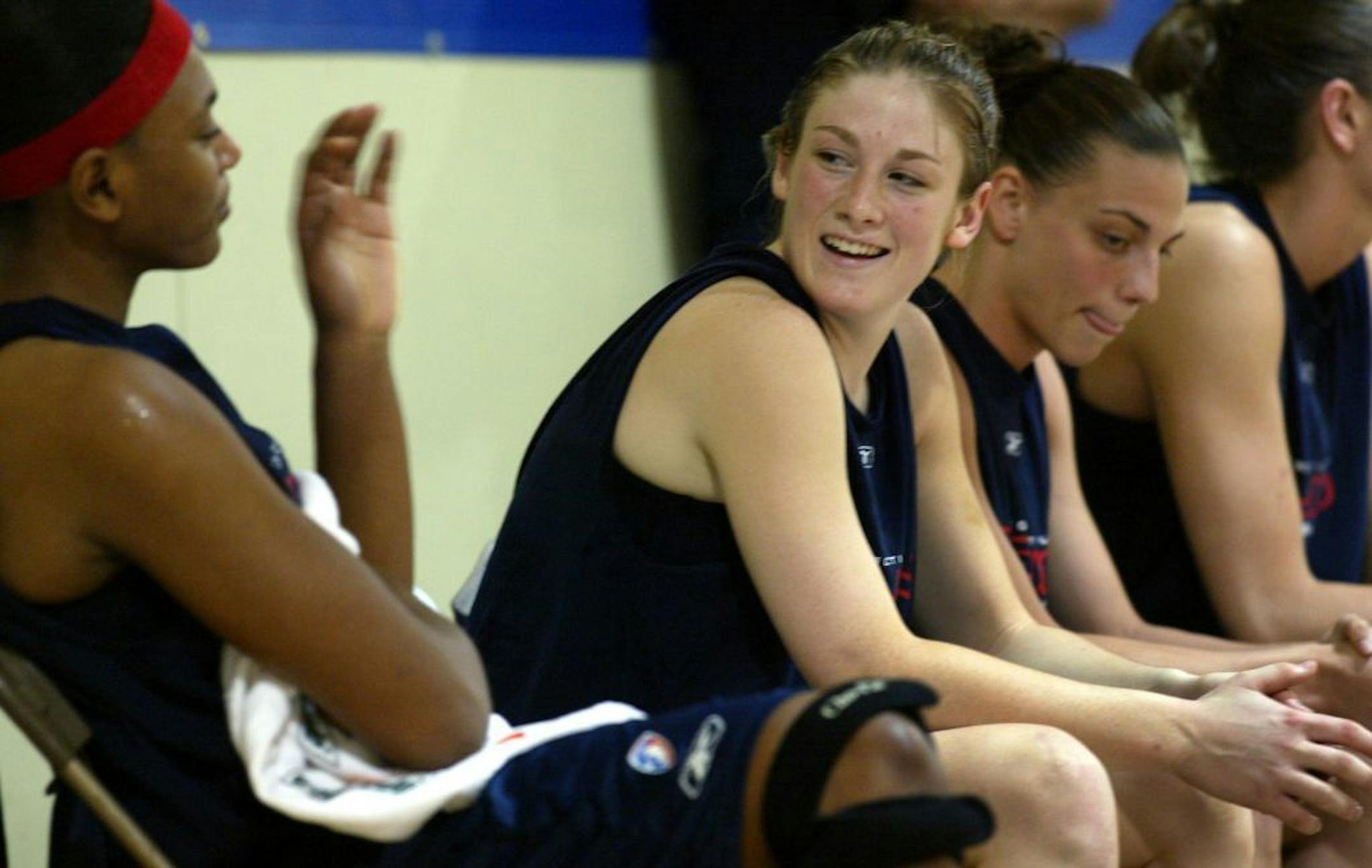 5/21/04 - Former University of MN Gopher star Lindsey Whalen makes the transition to the pros, training with the Connecticut Sun in preparation for her first WNBA season, which opens Saturday against Phoenix. THIS PHOTO: Seated next to fellow rookie Jen Derevjanik, right, Lindsey Whalen gets to know another teamamte, Asjha Jones, left, a former University of CT player while taking a break on the bench during a scrimmage at Connecticut College, the team's practice site.