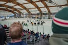 Fans watch from the stands as the Minnesota Wild held a free, open-to-the-public outdoor practice in St. Louis Park, Minn., on Saturday, Nov. 5, 2022.