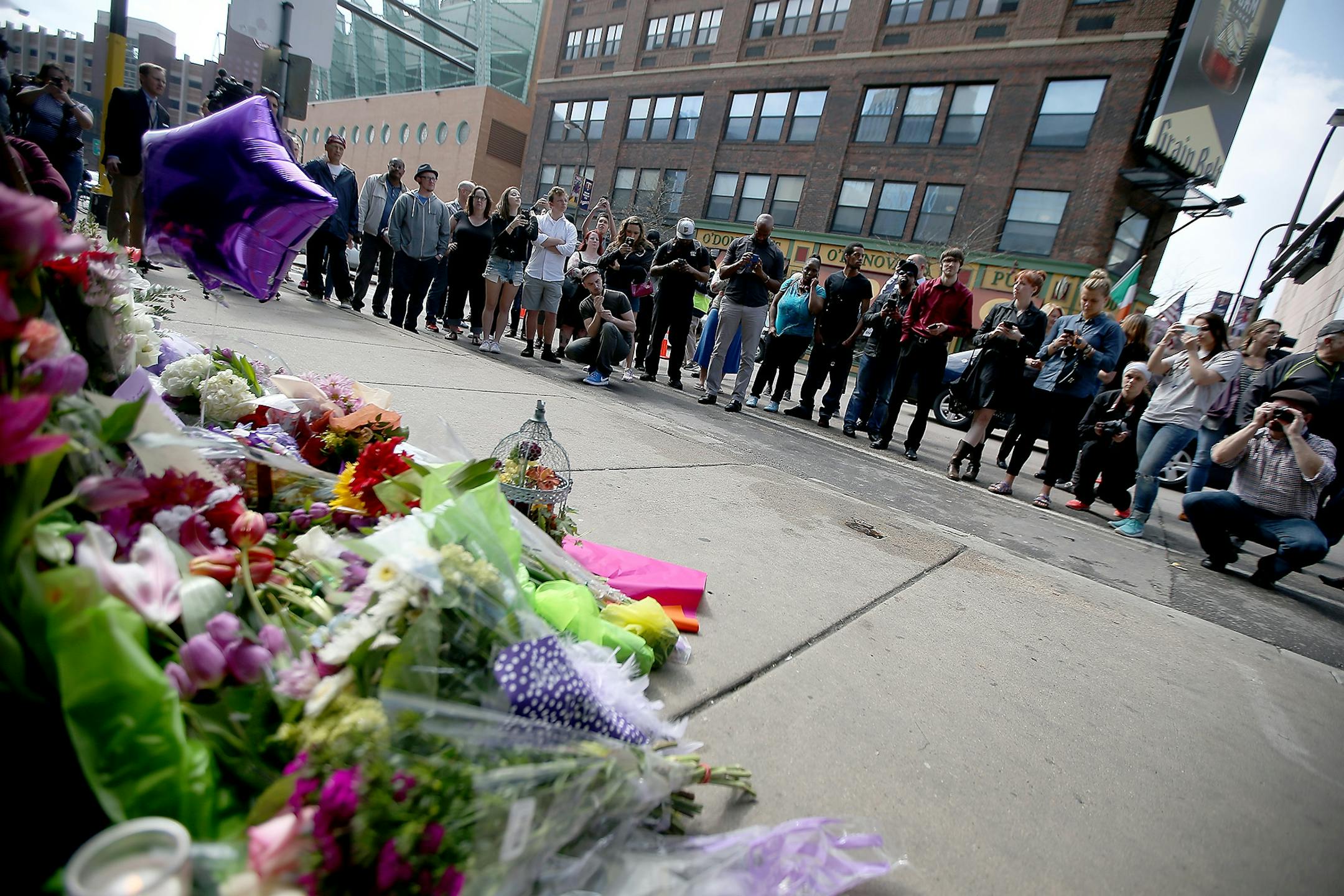 Many fans made their way to leave flowers beneath Prince's star or stop for photos at First Avenue after news of his death was made, Thursday, April 21, 2016 in Minneapolis, MN.