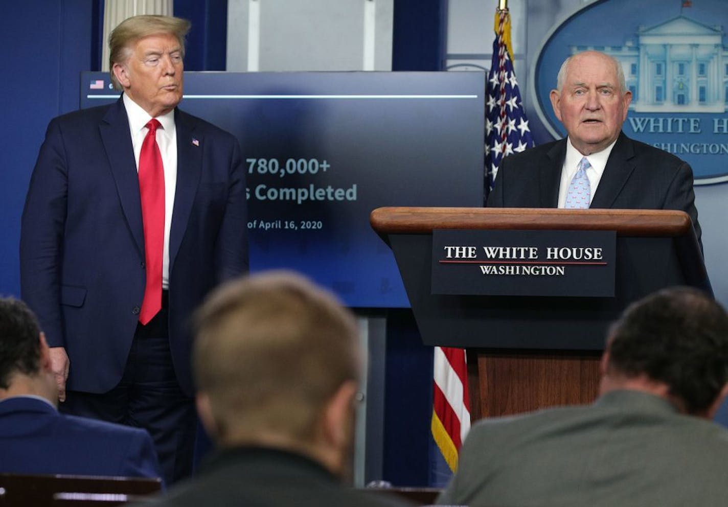 Secretary of Agriculture Sonny Perdue, right, speaks as President Donald Trump looks on during the daily briefing of the White House Coronavirus Task Force, at the White House in Washington, D.C., on Friday, April 17, 2020.