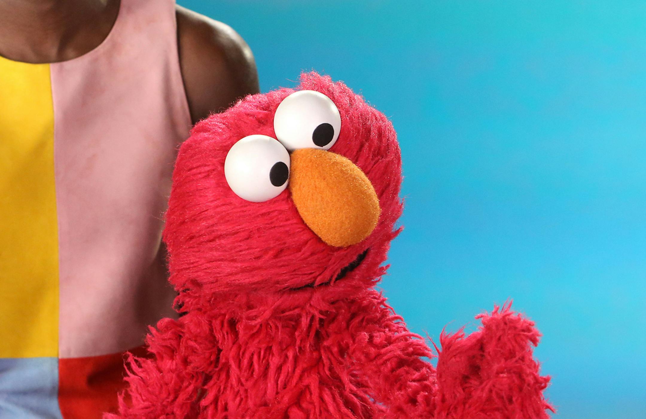 In this April 9, 2014 image released by the Sesame Workshop, Academy Award-winning actress Lupita Nyong'o, left, and character Elmo appear in a sketch for the children's program "Sesame Street"at Kaufman-Astoria Studios in the Astoria neighborhood of the Queens borough of New York. Sesame Street continues to attract millions of viewers after 45 years on the air, appealing to both preschoolers and their parents with content that is educational and entertaining. The show has kept up with the times