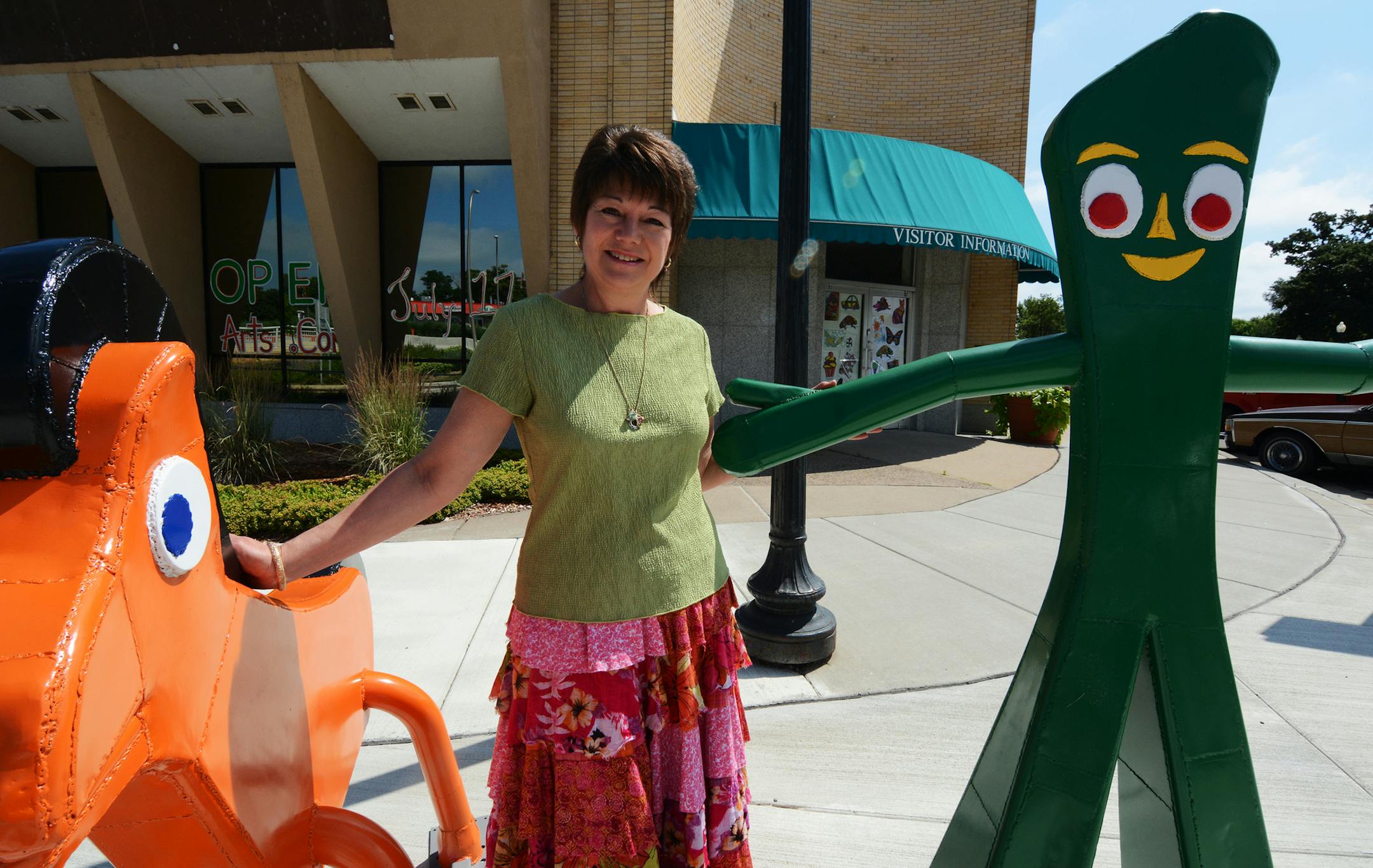 Mecca Page stands by metal sculptures by Dale Lewis in front of the new BreakAway Arts Center in Hastings. The business opened in mid-July.Photo by Liz Rolfsmeier, Special to the Star Tribune