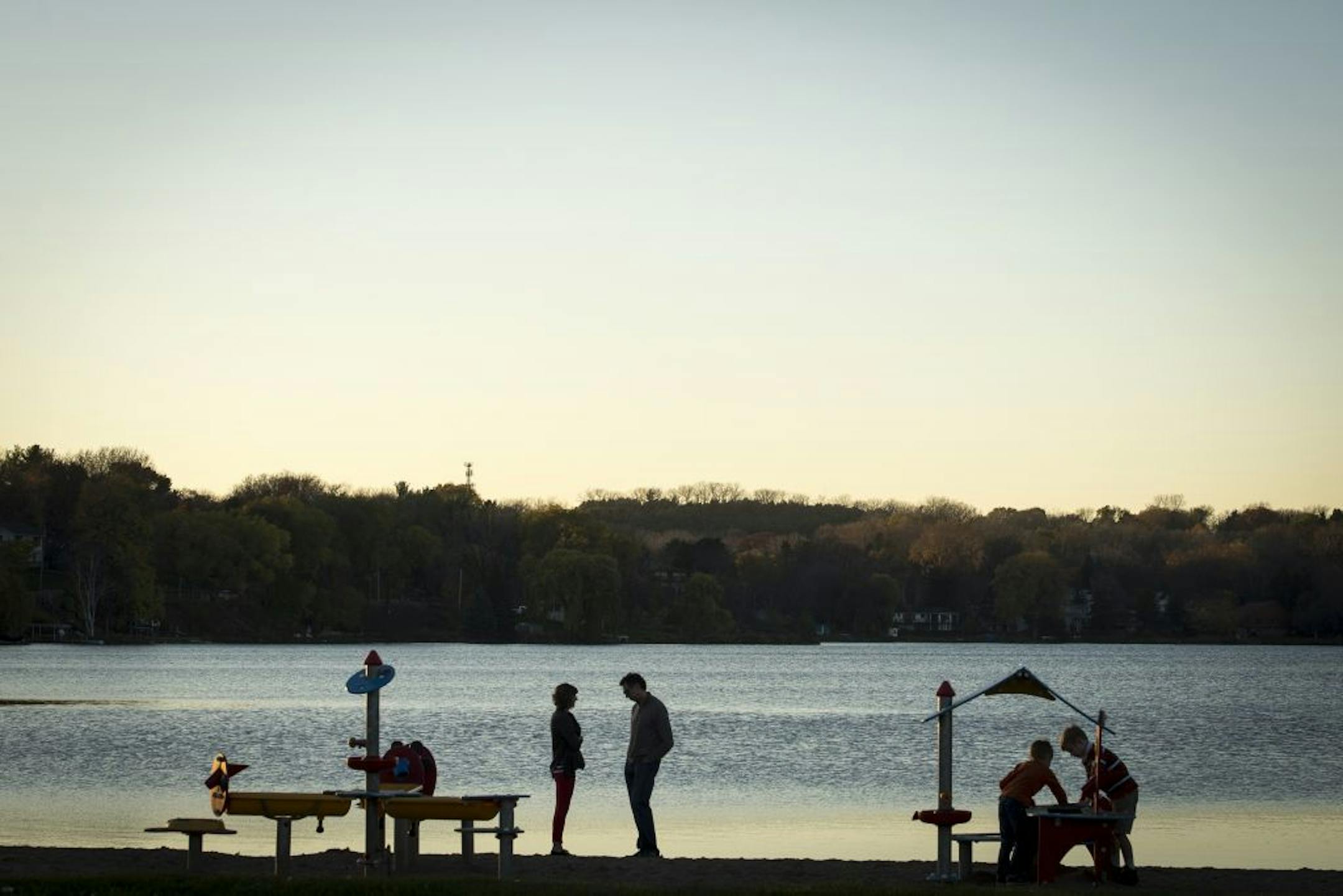 Jennifer and Mike Eastman-Loupe stood by the shore of McCarrons Lake as their two boys played nearby on Tuesday night.