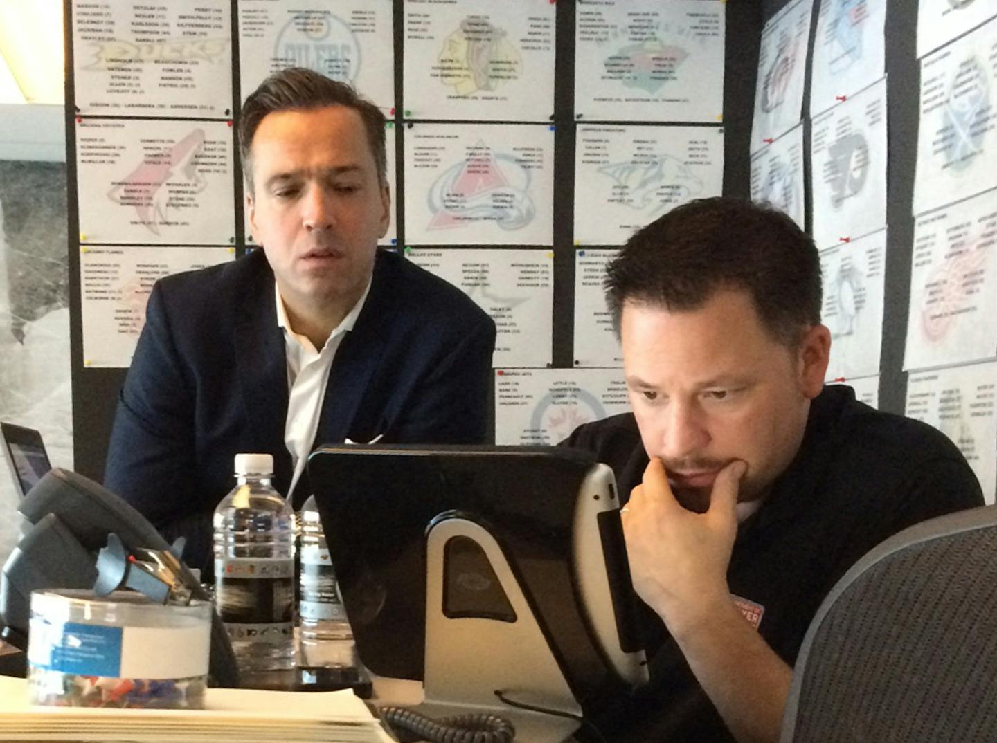 Photo by Michael Russo
The NHL's Department of Safety War Room in New York on Nov. 10, 2014. standing: Stephane Quintal, Senior Vice President, Player Safety
sitting staring at iPad: Damian Echevarrieta, Vice President