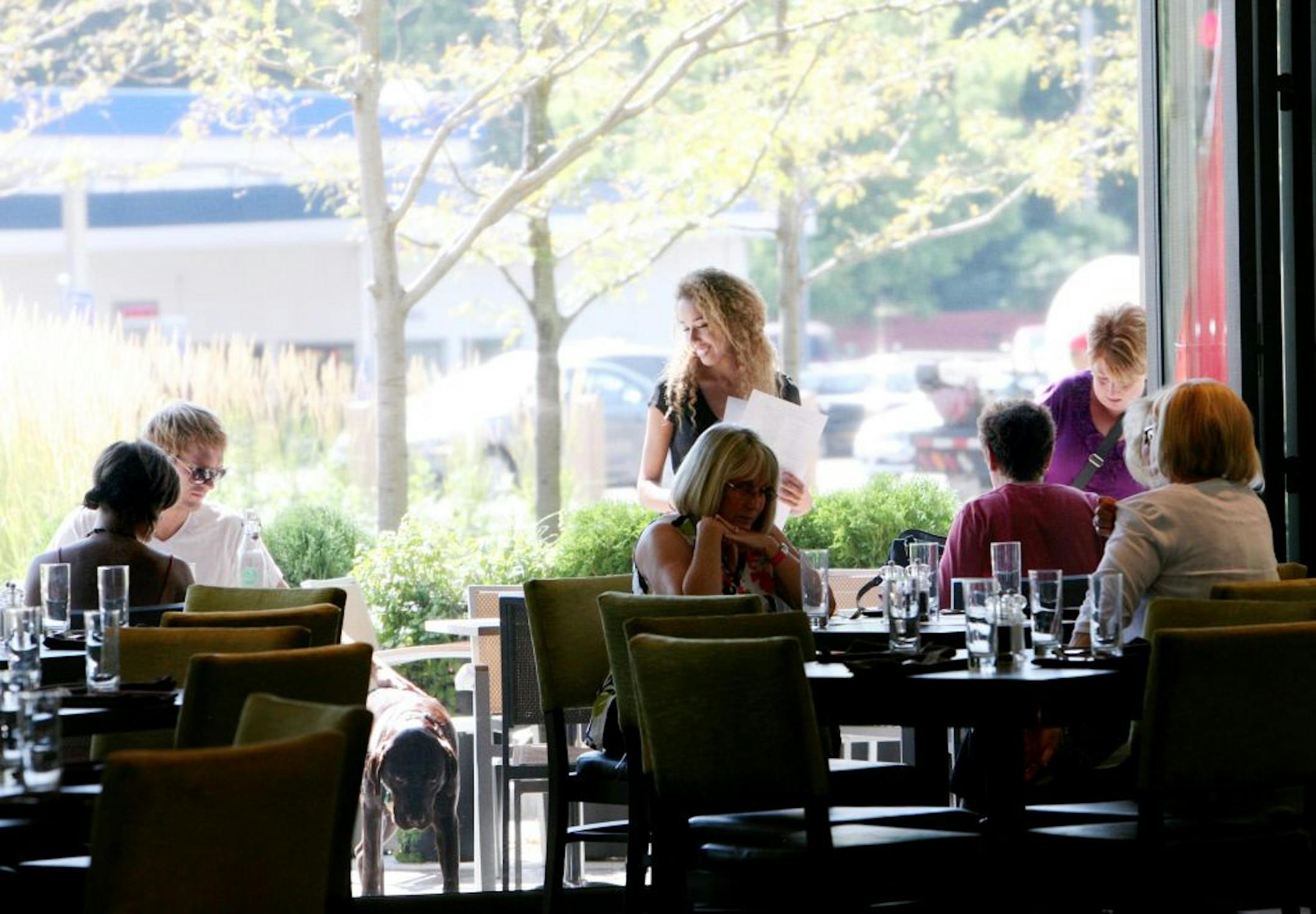 A spacious dining room spills out onto the patio, the two areas separated only by a floor-to-ceiling screen.