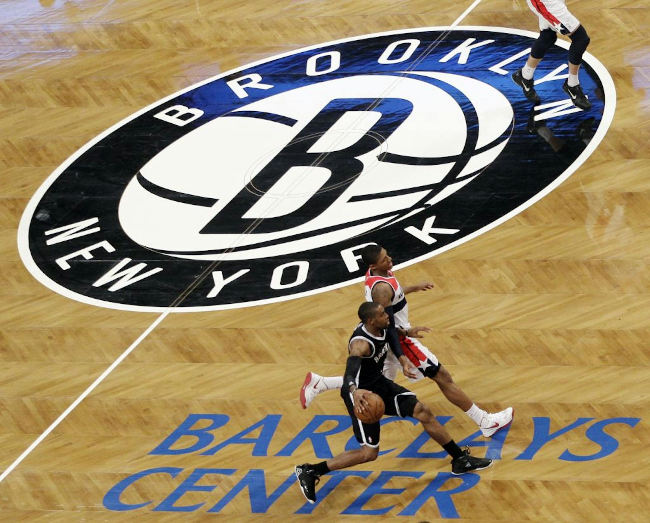 Brooklyn Nets guard C.J. Watson brings the ball downcourt against the Washington Wizards during the fourth quarter of their NBA preseason basketball game at Barclays Center
