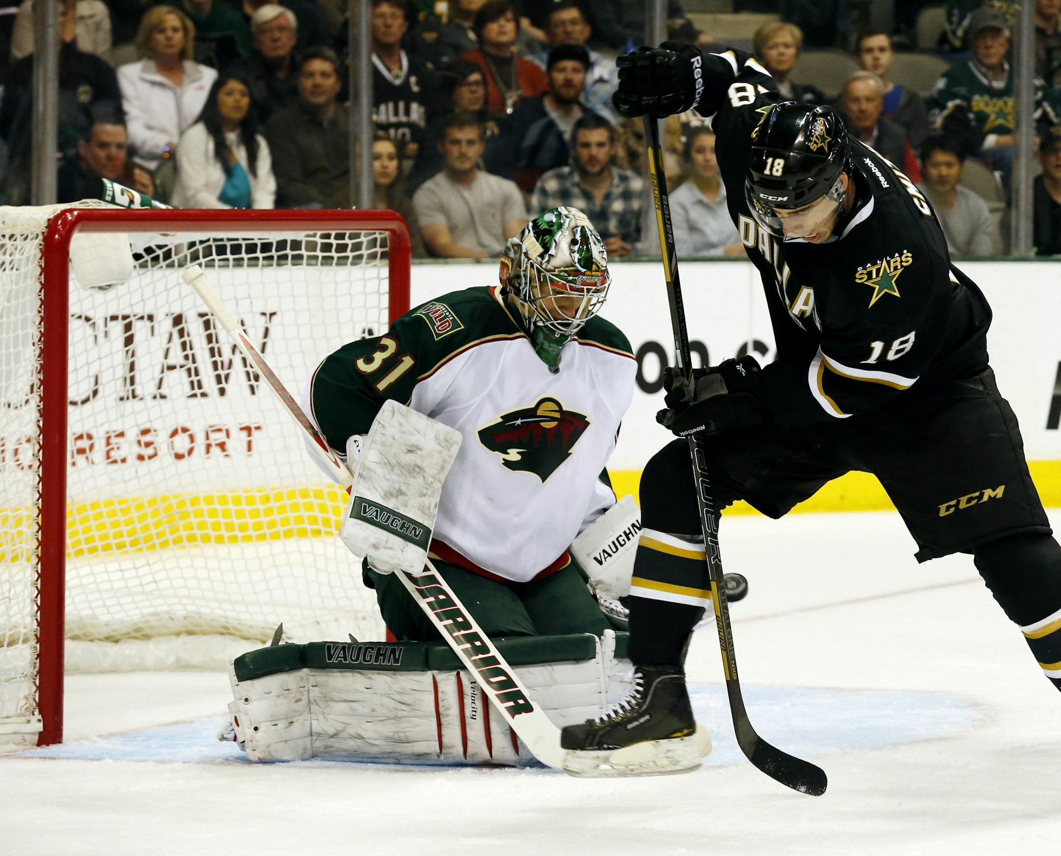 Minnesota Wild goalie Matt Hackett (31) and defenseman Ryan Suter (20) defend as Dallas Stars forward Reilly Smith (18) jumps out of the way of the puck during the first period of an NHL hockey game Friday, March 29, 2013, in Dallas, Texas. (AP Photo/Sharon Ellman)