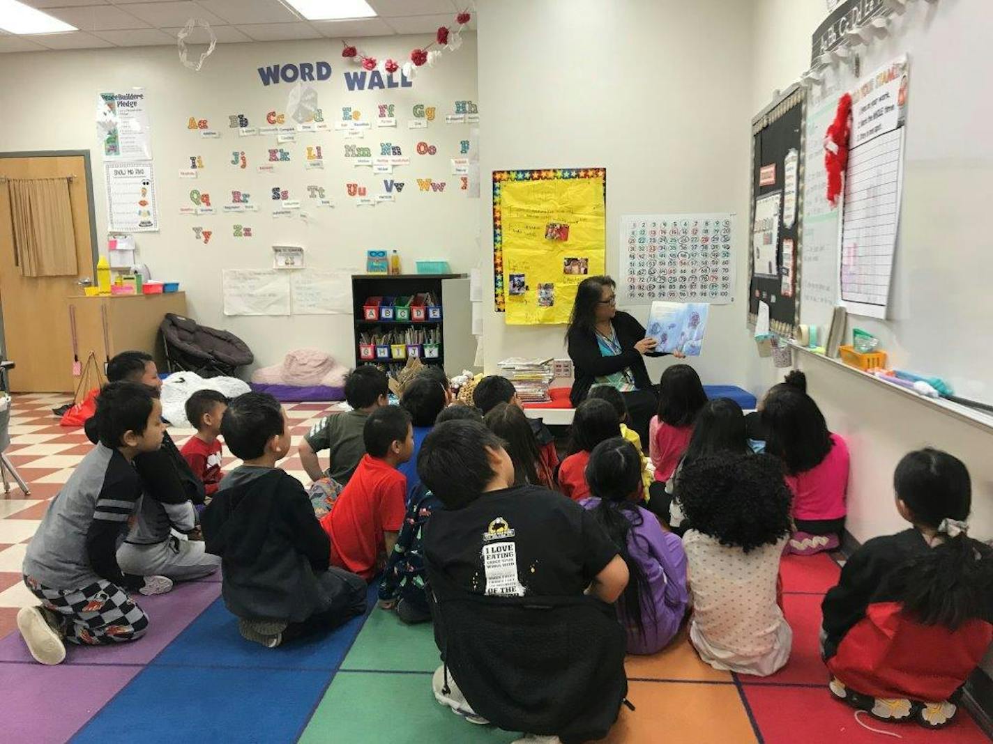 Choua Lee Yang reads to second graders at the Prairie Seeds Academy in Brooklyn Park.