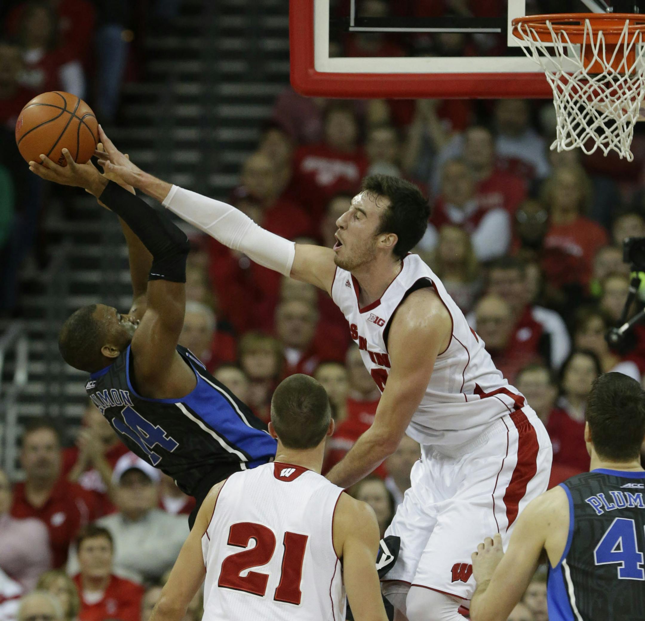 Wisconsin forward Frank Kaminsky, right, blocks a shot by Duke guard Rasheed Sulaimon during the first half of their game Wednesday, Dec. 3, 2014 at the Kohl Center in Madison, Wis. Kaminsky was injured on the play, but returned to the game. Duke won 80-70. (Mark Hoffman/Milwaukee Journal Sentinel/TNS) ORG XMIT: 1160964