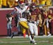 USC kickoff specialist Robert Woods (13) ran a 3rd quarter kickoff back for a 97-yard touchdown run beating Gophers Brock Vereen (21) on the play. The
