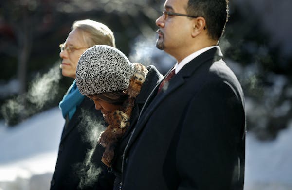 Minnetonka resident Kissy Mason, center, who was denied a job from Target, stood between State Representative Raymond Dehn, left, and President of the