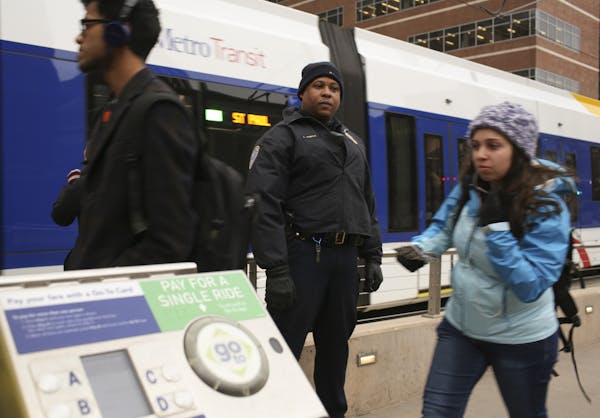 Transit officer LaFayette Temple checked for valid passes or receipts from riders at the East Bank Station last month.