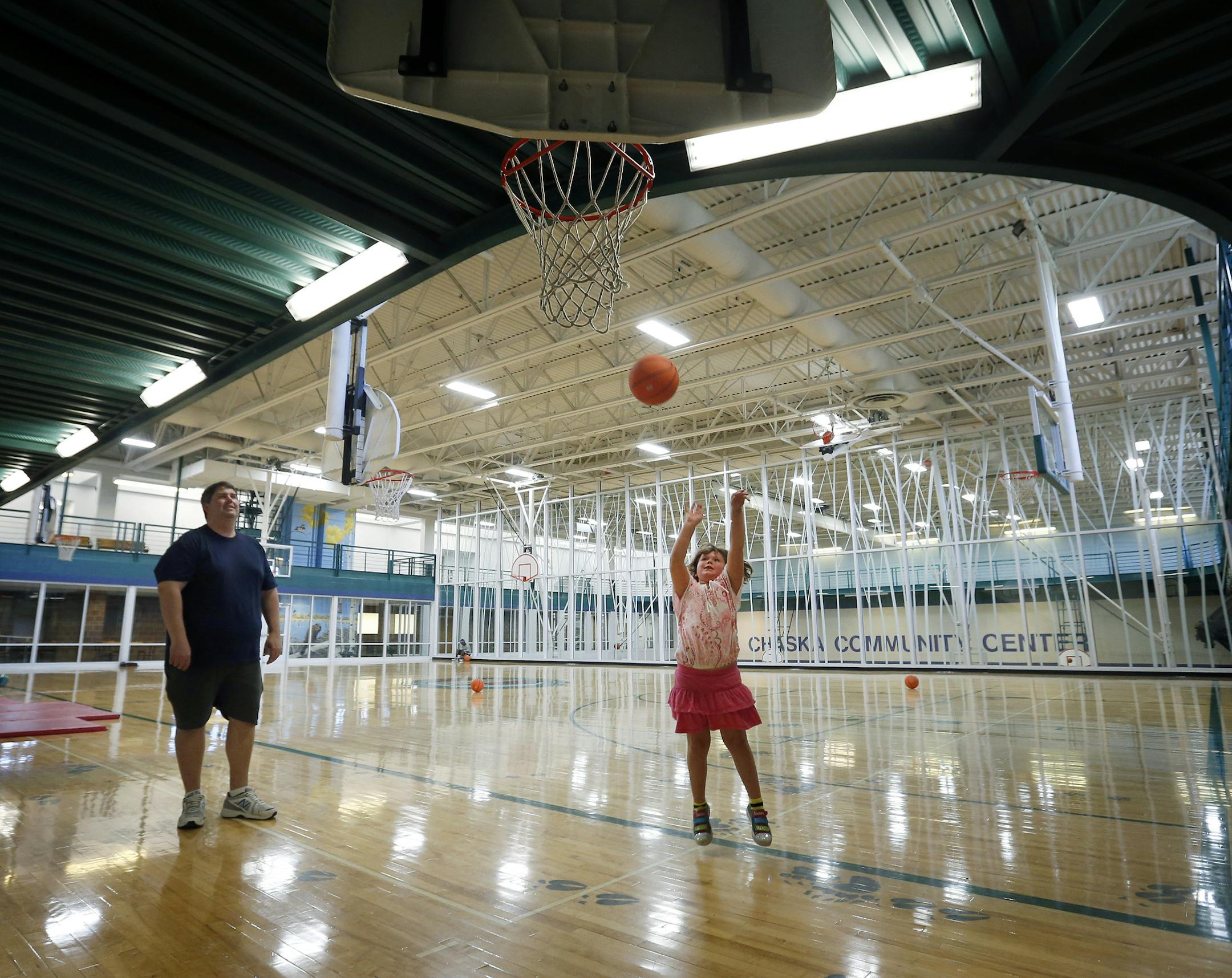 Katie Colleran, 7, played basketball with her father Mike at the Chaska Community Center on Thursday. ] CARLOS GONZALEZ cgonzalez@startribune.com August 22, 2013, Chaska, Minn., Chaska Community Center