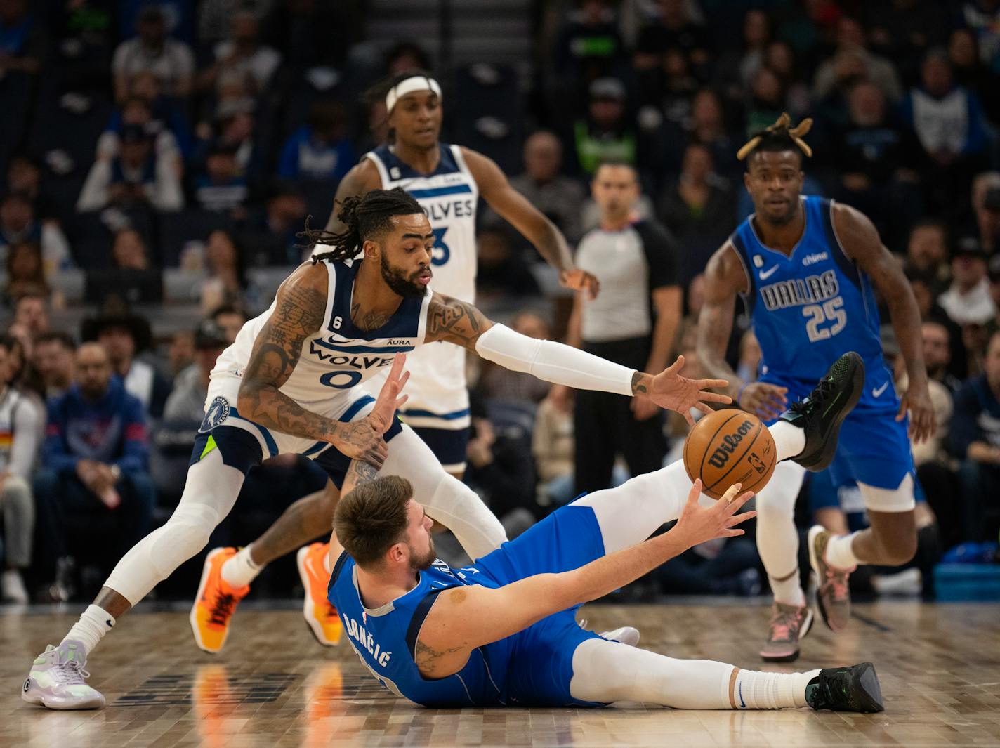 Minnesota Timberwolves guard D'Angelo Russell (0) took the ball away from Dallas Mavericks guard Luka Doncic (77) in the first quarter Monday night, December 19, 2022. The Minnesota Timberwolves faced the Dallas Mavericks in an NBA basketball game at Target Center in Minneapolis. ] JEFF WHEELER • jeff.wheeler@startribune.com