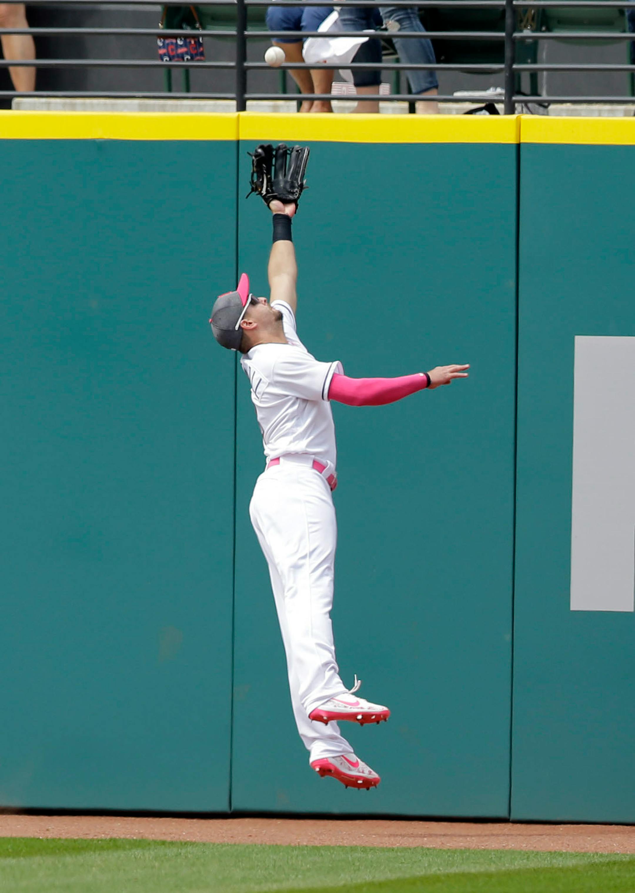 Cleveland Indians' Lonnie Chisenhall jumps for a ball hit for a double by Minnesota Twins' Kennys Vargas in the sixth inning of a baseball game, Sunday, May 14, 2017, in Cleveland. Joe Mauer and Miguel Sano scored on the play.