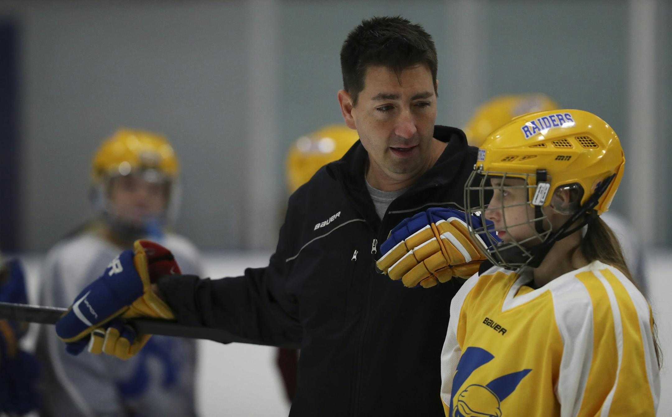 New Hastings girls' hockey coach Josh Colvin chatted with Lauren Tix during practice Wednesday afternoon. (Jeff Wheeler/Star Tribune)