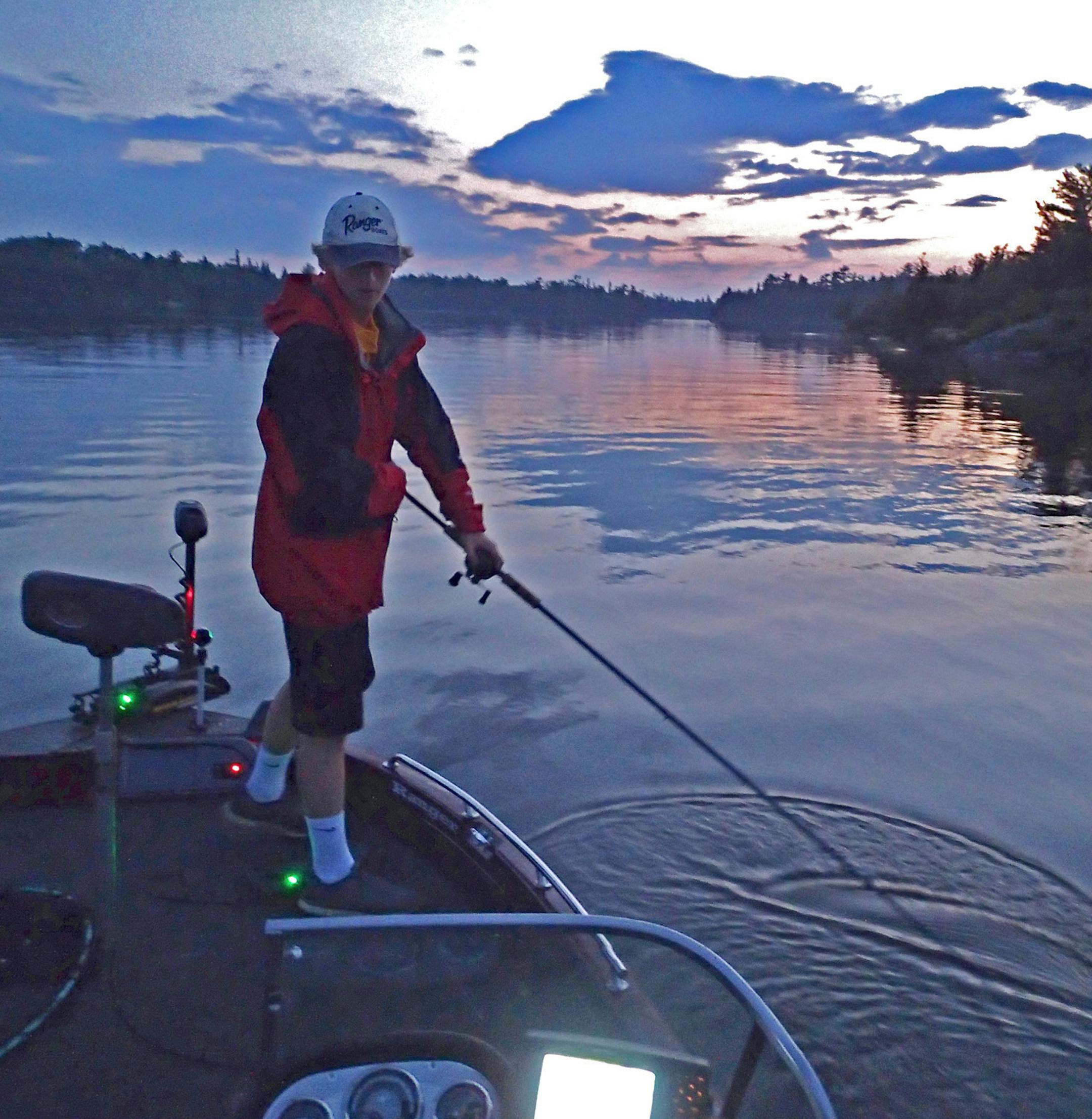 Fishing amid beautiful surroundings is a benefit to casting for muskies on Lake of the woods. Here Cole Anderson circled his lure boatside after a retrieve, hoping to entice a fish that might have followed the bait to bite.