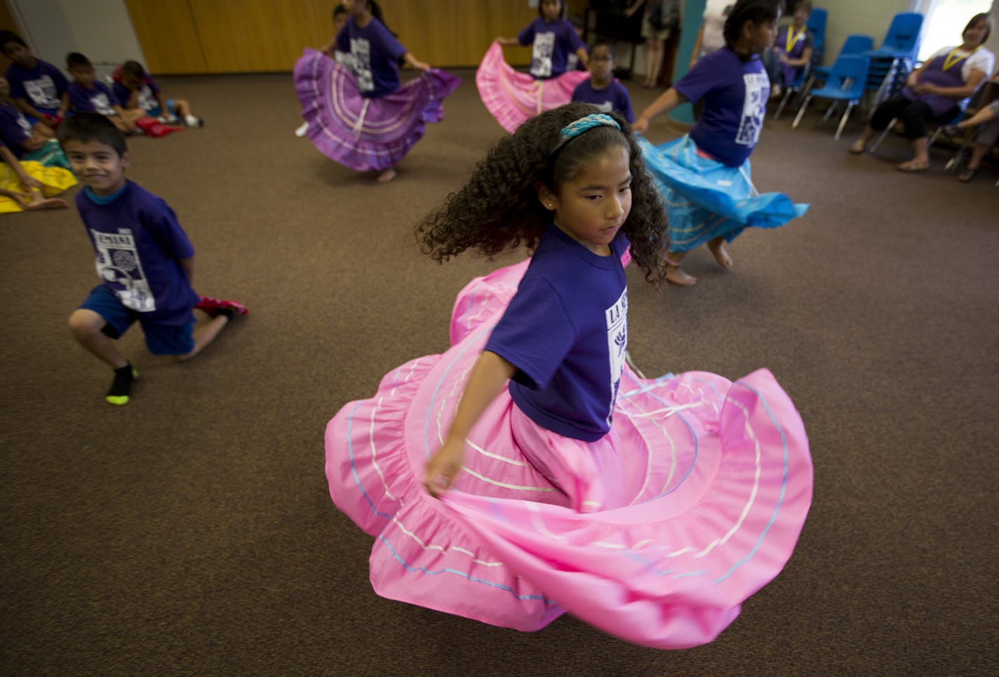 More than 450 children adopted from Latin America converged in the south metro last week (July 28-Aug. 1) for La Semana Culture Camp. The camp, now in its 33rd year, celebrates the campers' countries of origin. They learn dance, language, arts and crafts and form friendships with other kids who look like them. Here, Mayah Gorder spins her traditional dres during dance practice. ] BRIAN PETERSON &#x201a;&#xc4;&#xa2; brian.peterson@startribune.com Lakeville, MN 07/30/14