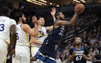 Andrew Wiggins glided between Golden State guard Klay Thompson, right, and forward Omri Casspi in the first half of Sunday's Wolves victory and stayed