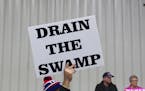 FILE - In this Oct. 27, 2016, file photo, supporters of then-Republican presidential candidate Donald Trump hold signs during a campaign rally in Spri