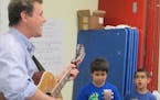 Photo by Shannon Melham: Singer-songwriter James Hersch, musician-in-residence at Anoka County libraries, with students from his workshop at Banfill-L