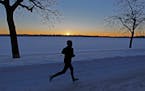 Angela Gustafson braved the -13 degree temperatures for a run around Lake Harriet at sunrise, Tuesday, January 28, 2014 in Minneapolis, MN. (ELIZABETH