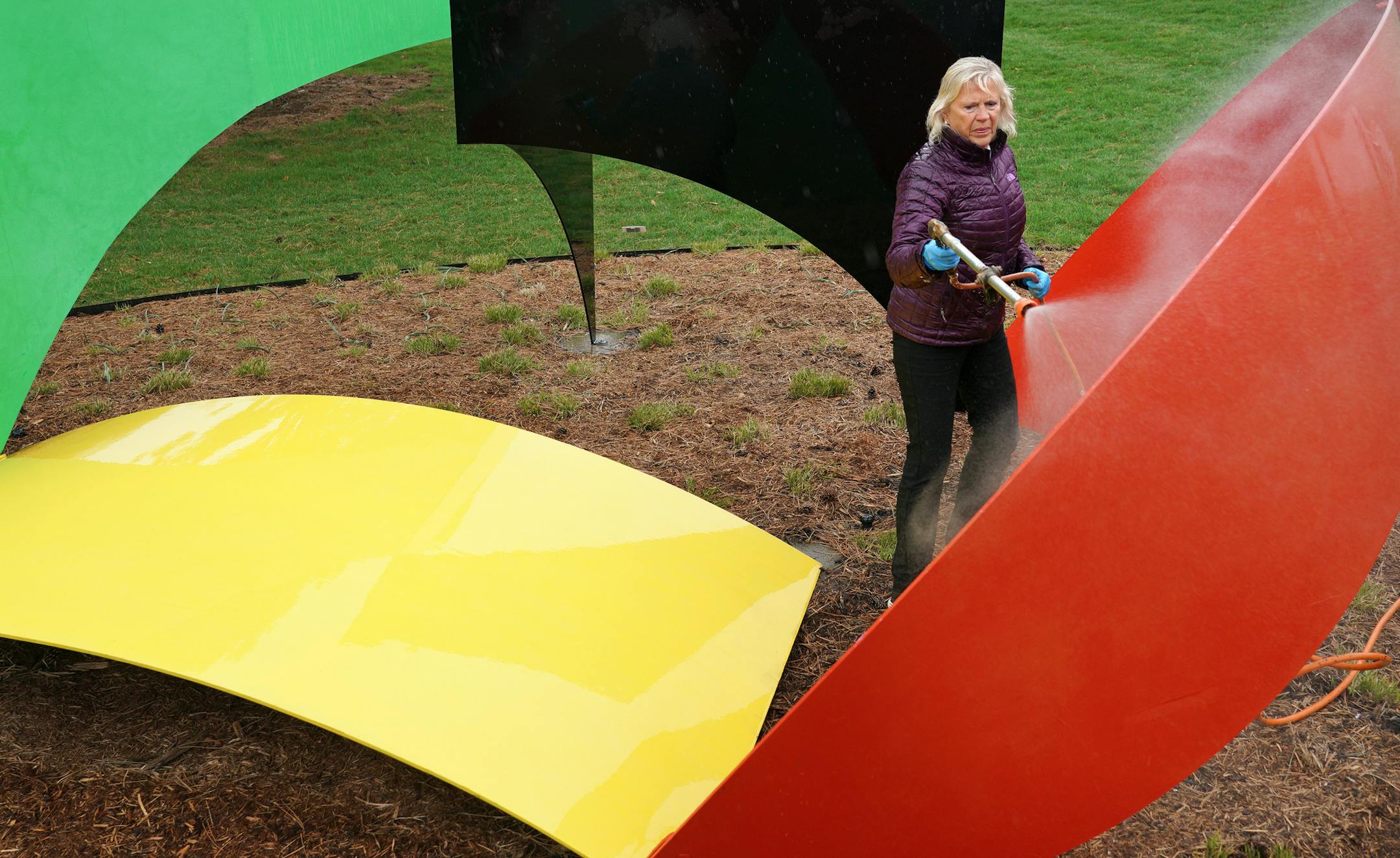 Diane Shelgren cleaned "Wayzata Reel" by Philip King at the Minnesota Landscape Arboretum's Harrison Scupture Garden.