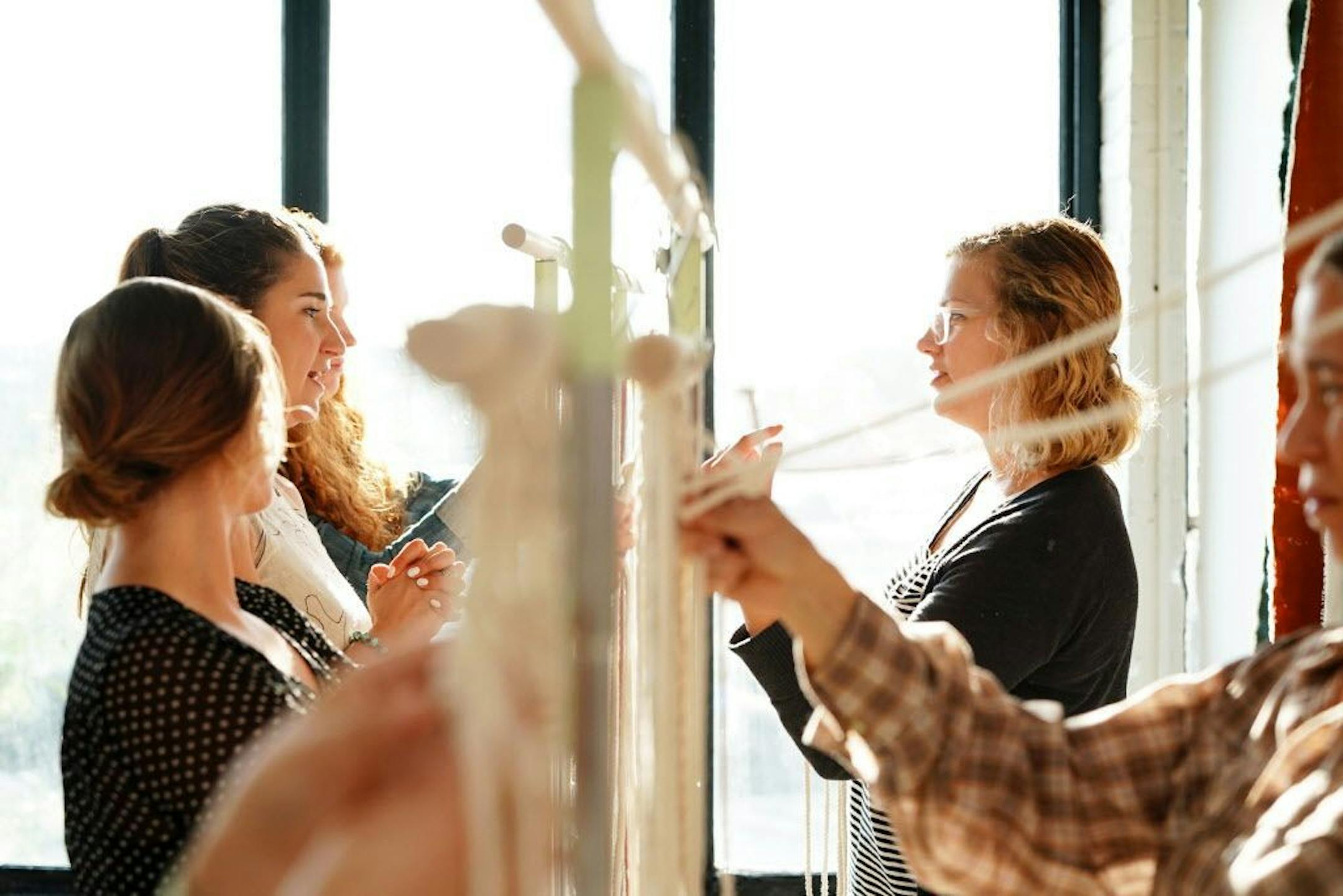 Danielle Massa, right, worked on her project alongside other students during Emily Katz's macrame class.