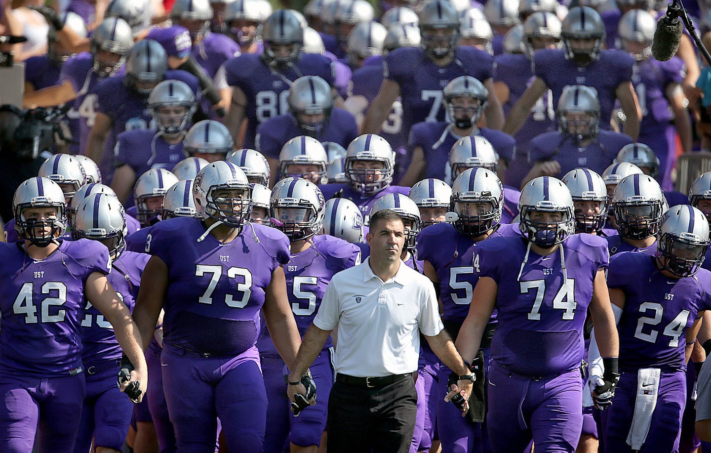 St. Thomas head coach Glen Caruso led his team on to the field before the game. ] JIM GEHRZ &#xe2;&#x20ac;&#xa2; jgehrz@startribune.com / St. Paul, MN / Sept. 27, 2014 / 1:00 PM / BACKGROUND INFORMATION: St. Thomas University played St. John&#xe2;&#x20ac;&#x2122;s University in MIAC matchup at O&#xe2;&#x20ac;&#x2122;Shaughnessy Stadium. St. John&#xe2;&#x20ac;&#x2122;s won the game by a score of 24-14. ORG XMIT: MIN1409271747060252