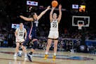 Iowa guard Caitlin Clark shoots a three-pointer over UConn guard Nika Muhl in the second half. Clark is the biggest name in college basketball, but th
