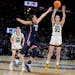 Iowa guard Caitlin Clark shoots a three-pointer over UConn guard Nika Muhl in the second half. Clark is the biggest name in college basketball, but th