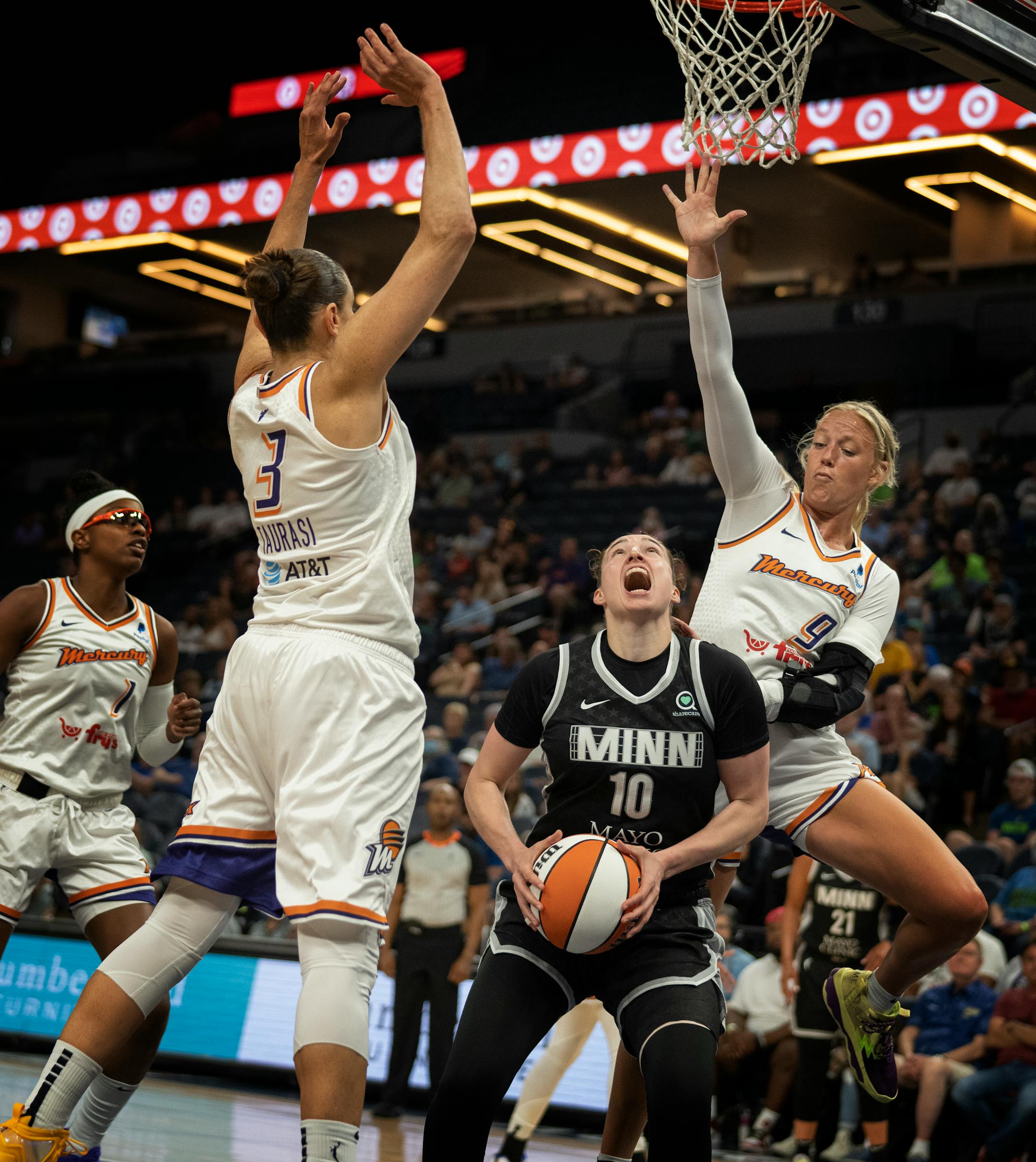 Minnesota Lynx forward Jessica Shepard (10) was pressured by Phoenix Mercury guard Diana Taurasi (3) and her teammate Sophie Cunningham (9)in the first half.